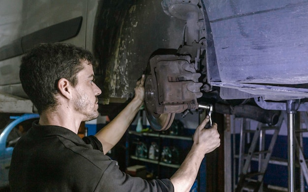 Repairman installing brake discs in workshop