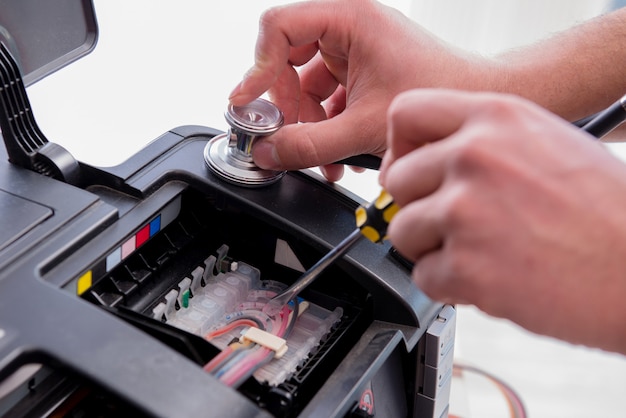 Repairman repairing broken color printer