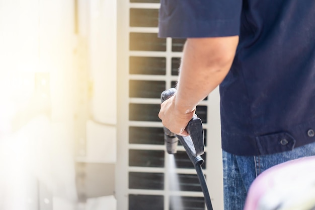 Repairman washing dirty compartments air conditioner Male technician cleaning air conditioner indoors Maintenance and repairing concepts