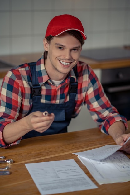 Repairman with a cheerful smile preparing for work