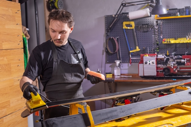 A repairman in workshop repairing ski