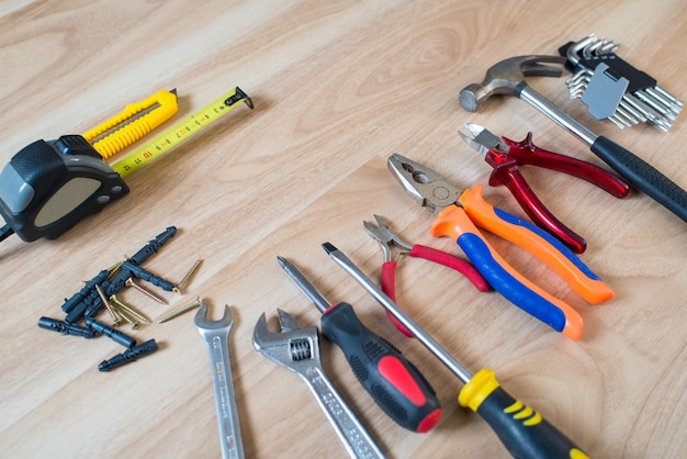 Repairs or construction tools on wooden background