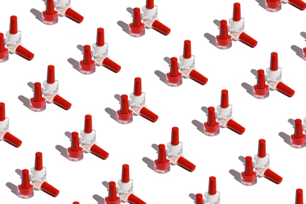 Repetitive pattern with nail polish bottles on white background