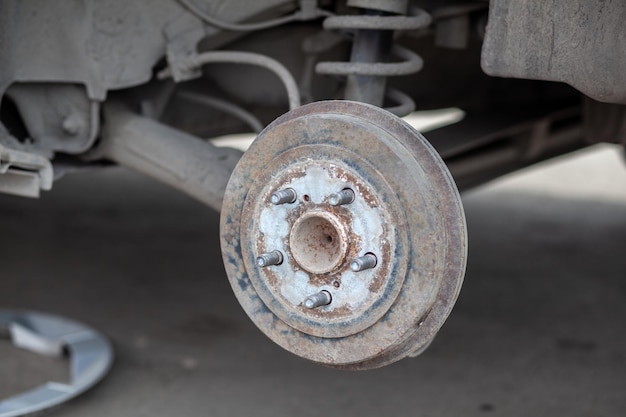 Replacement of brake pads Car brake repairing in garage Suspension of car for maintenance brakes