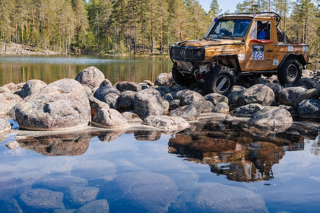 REPUBLIC OF KARELIA RUSSIA CIRCA JUNE 2022 Offroad tournament Ladoga Trophy 2022 around Lake Ladoga SUV jeep 4x4 Mercedes rides on rocks