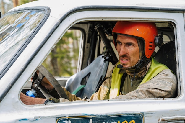 REPUBLIC OF KARELIA RUSSIA CIRCA JUNE 2022 Offroad tournament Ladoga Trophy 2022 in Karelia Emotional portrait of a racer driver driving a 4x4 jeep SUV