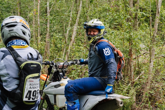 REPUBLIC OF KARELIA RUSSIA CIRCA JUNE 2022 Offroad tournament Ladoga Trophy 2022 in Karelia A motorcycle racer in a helmet sitting on a sports motorcycle