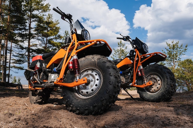 REPUBLIC OF KARELIA RUSSIA CIRCA JUNE 2022 Offroad tournament Ladoga Trophy 2022 in Karelia Two offroad sports motorcycles are parked on the beach in the woods