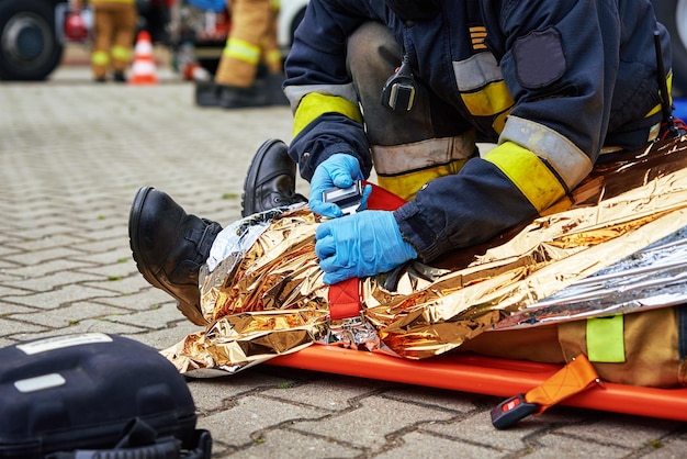 Rescuers provide first aid to the victim during car road accident