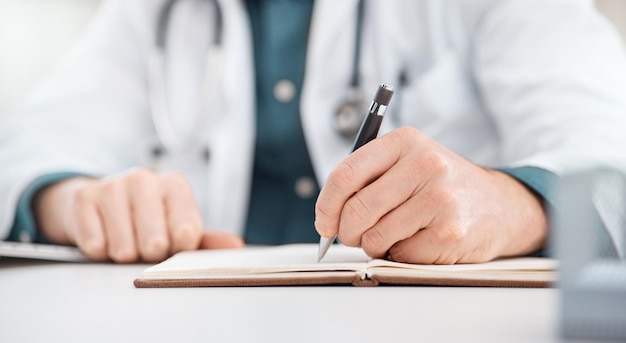 Research and planning is number one Closeup shot of an unrecognisable doctor writing notes in a medical office