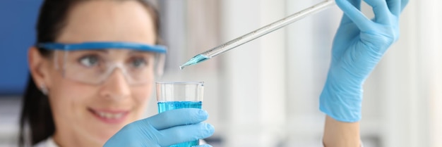 Researcher scientist working with blue liquid test tube in laboratory chemical science or