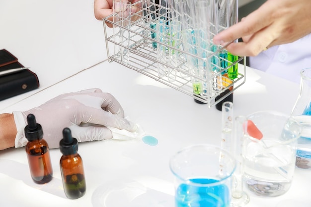 Researcher or scientists clean chemicals spilled onto the table in laboratory