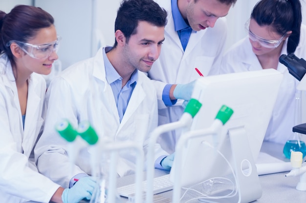 Researchers looking at computer screen in the lab