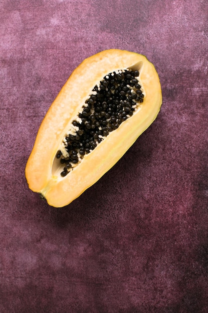 Resh ripe papaya slice on with papaya seed top view