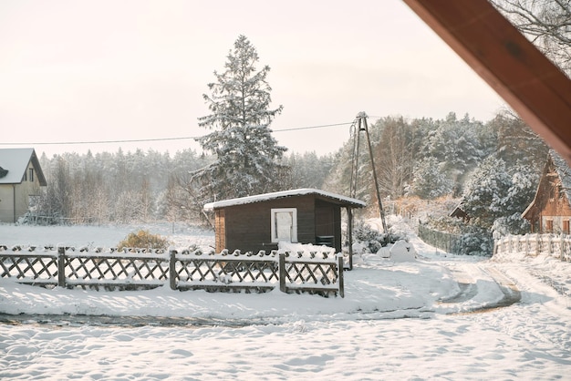 Residential house in the winter A dwelling cottage in a rural is covered with freshly fallen snow