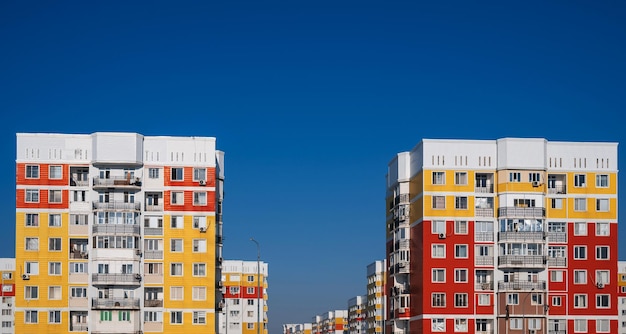 Residential new houses with windows and balconies on sky background