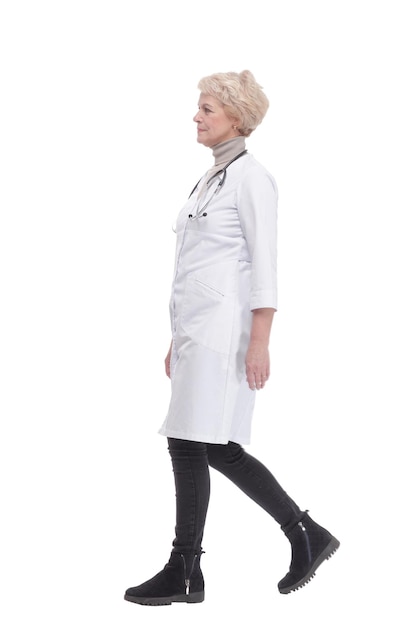 Responsible female doctor with a stethoscope striding forward