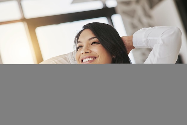 Rest happy and business woman in the office with a complete done and successful project Relax smile and professional female corporate employee stretching after working on report in the workplace