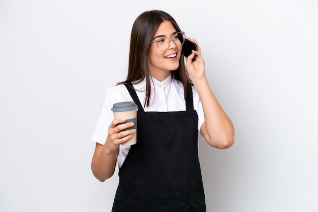 Restaurant Brazilian waiter woman isolated on white background holding coffee to take away and a mobile