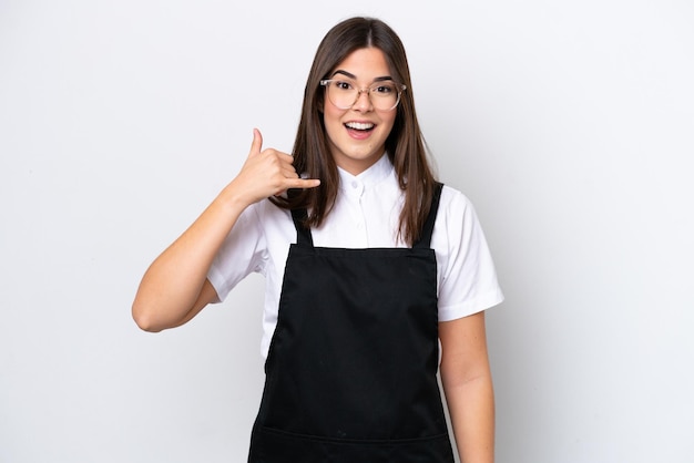 Restaurant Brazilian waiter woman isolated on white background making phone gesture Call me back sign