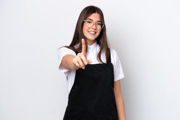 Restaurant Brazilian waiter woman isolated on white background showing and lifting a finger