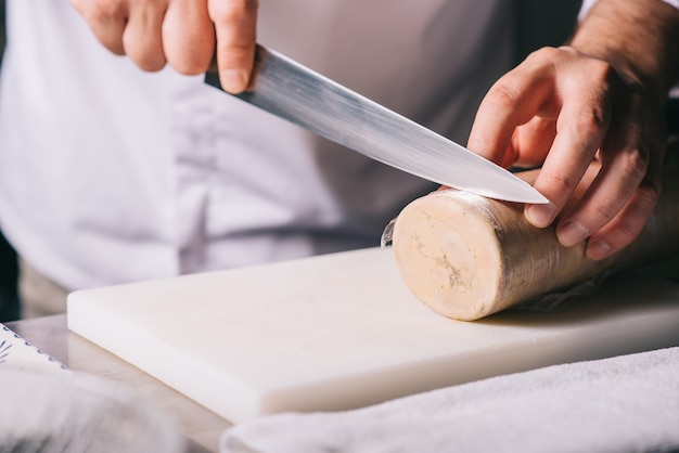 Restaurant chef cutting foie gras