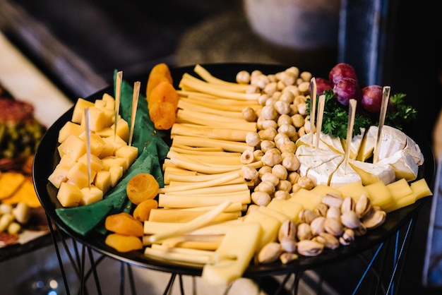 Restaurant food Plate with cheese nuts Pub menu snack Highcalorie snack for beer Tasty delicious snacks Close up