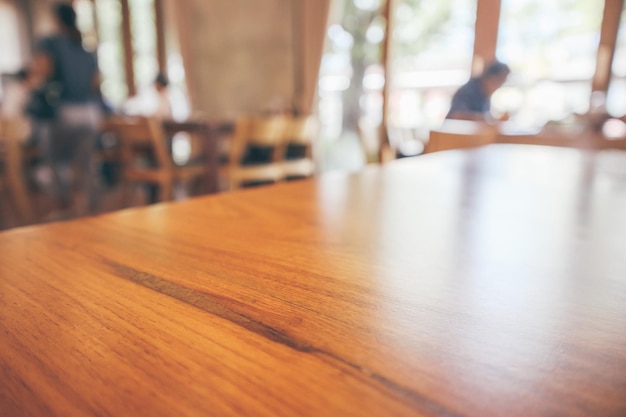 Restaurant interior with customer and wood table blur abstract background with bokeh light