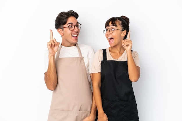 Restaurant mixed race waiters isolated on white background intending to realizes the solution while lifting a finger up