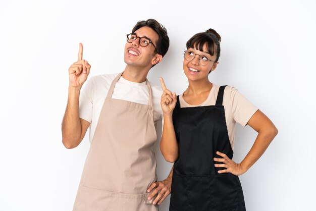 Restaurant mixed race waiters isolated on white background pointing a great idea and looking up