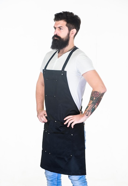 Restaurant staff. Waiter or bartender. Ready serve drink. Bearded hipster wear apron. Man cook brutal hipster. Serious bearded cook. Hipster professional barista apron uniform. Fast food restaurant.