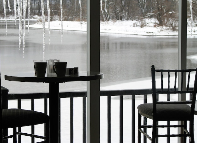 Restaurant table by the window with view of frozen winter river