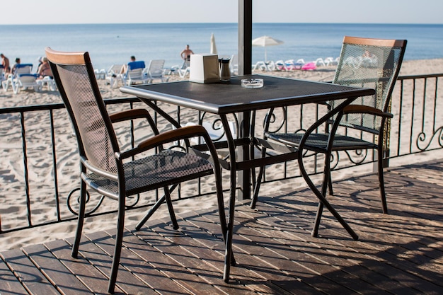 Restaurant tables on the terrace near the beach