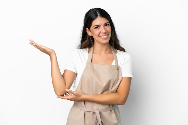 Restaurant waiter over isolated white background extending hands to the side for inviting to come