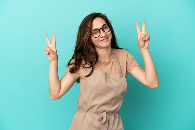 Restaurant waiter showing victory sign with both hands