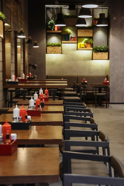 A restaurant with a wall of plants and a table with the words " food " on it.