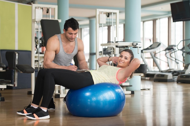 Resting Time  Confident Muscled Young Man Resting In Healthy Club Gym After Exercising