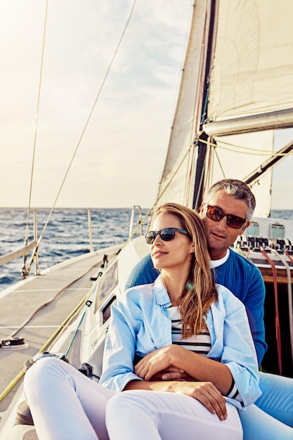 Retirement investment and luxury with couple on yacht for summer relax and wealth on Bali trip Travel love and ship with baby boomers man and woman sailing on boat for tropical vacation at sea