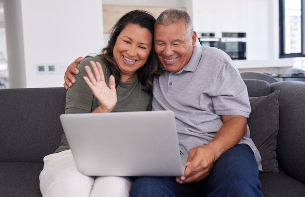 Retirement video call and laptop with couple on sofa for communication digital and internet Happy technology and online with elderly man and old woman in living room for family website and relax