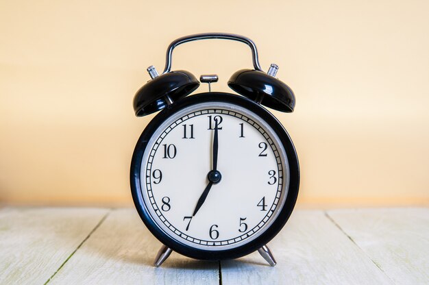 Retro alarm clock on wooden table