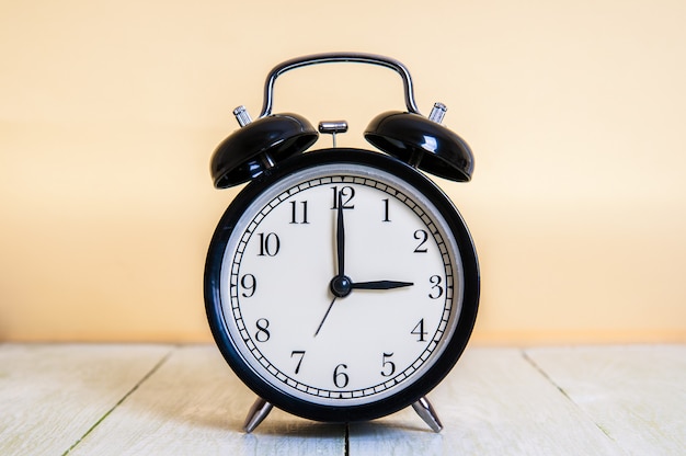 Retro alarm clock on wooden table