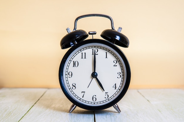 Retro alarm clock on wooden table