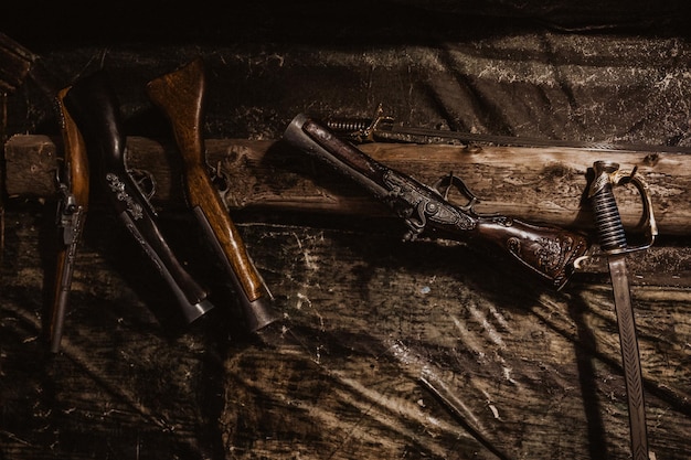 Retro antique pistol musket and swords hanging on the wall