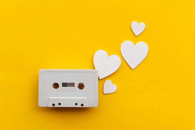 retro audio cassette tape surrounded by white love hearts.