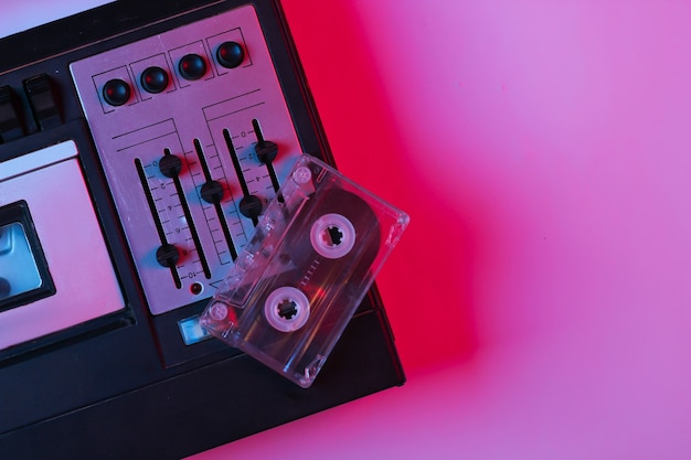 Retro audio tape recorder, audio cassette in pink blue gradient neon light