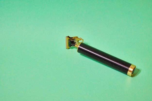 Retro beard and hair trimmer on a green background