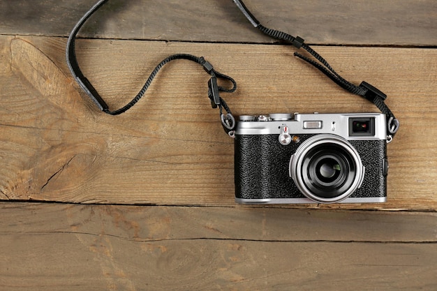 Retro camera on wooden planks background