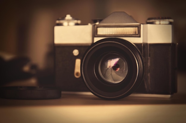 Retro camera on wooden surface closeup