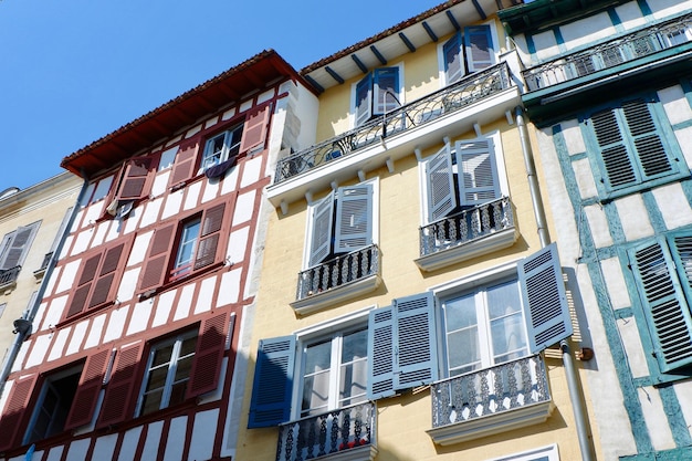 Retro colourful buildings with old fashioned windows and balconies on the street downtown Bayonne