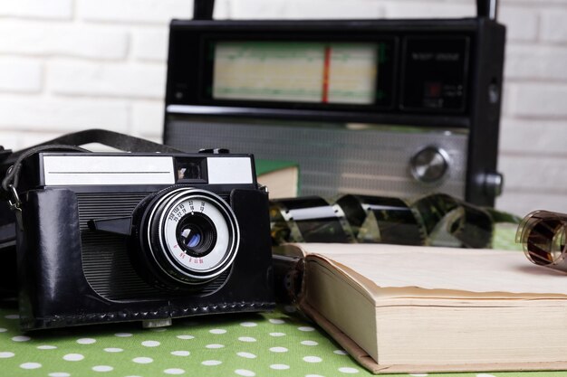 Retro composition with old camera radio and books close up